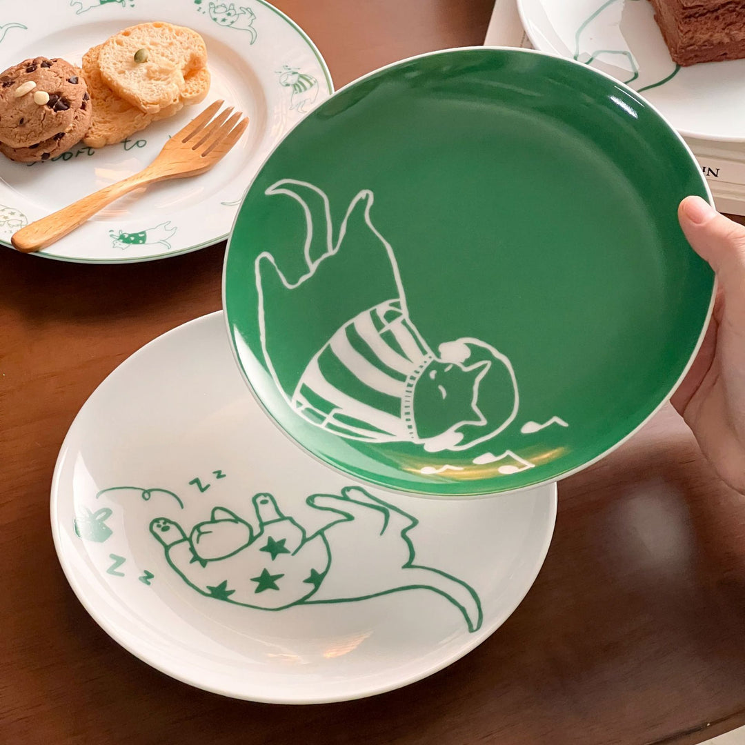 Decorative ceramic plate with cat motif and green border decoration