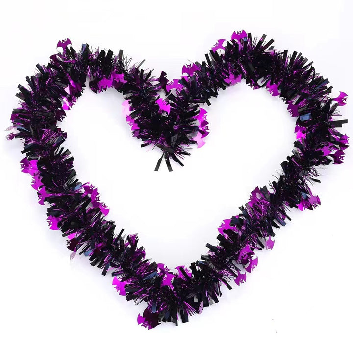 Shiny Halloween garland made of plastic with pumpkin confetti and dense fringes