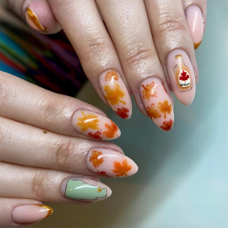 Artificial nail set with autumn leaf decorations and elegant color gradients Kalsten
