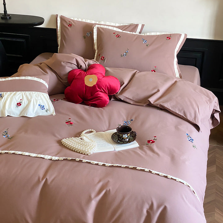 Duvet cover set made of premium cotton satin with subtly embroidered wildflower motif and ruffle edge