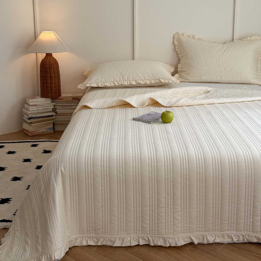 Quilted bedspread with frill and fine line quilting made of cotton blend fabric