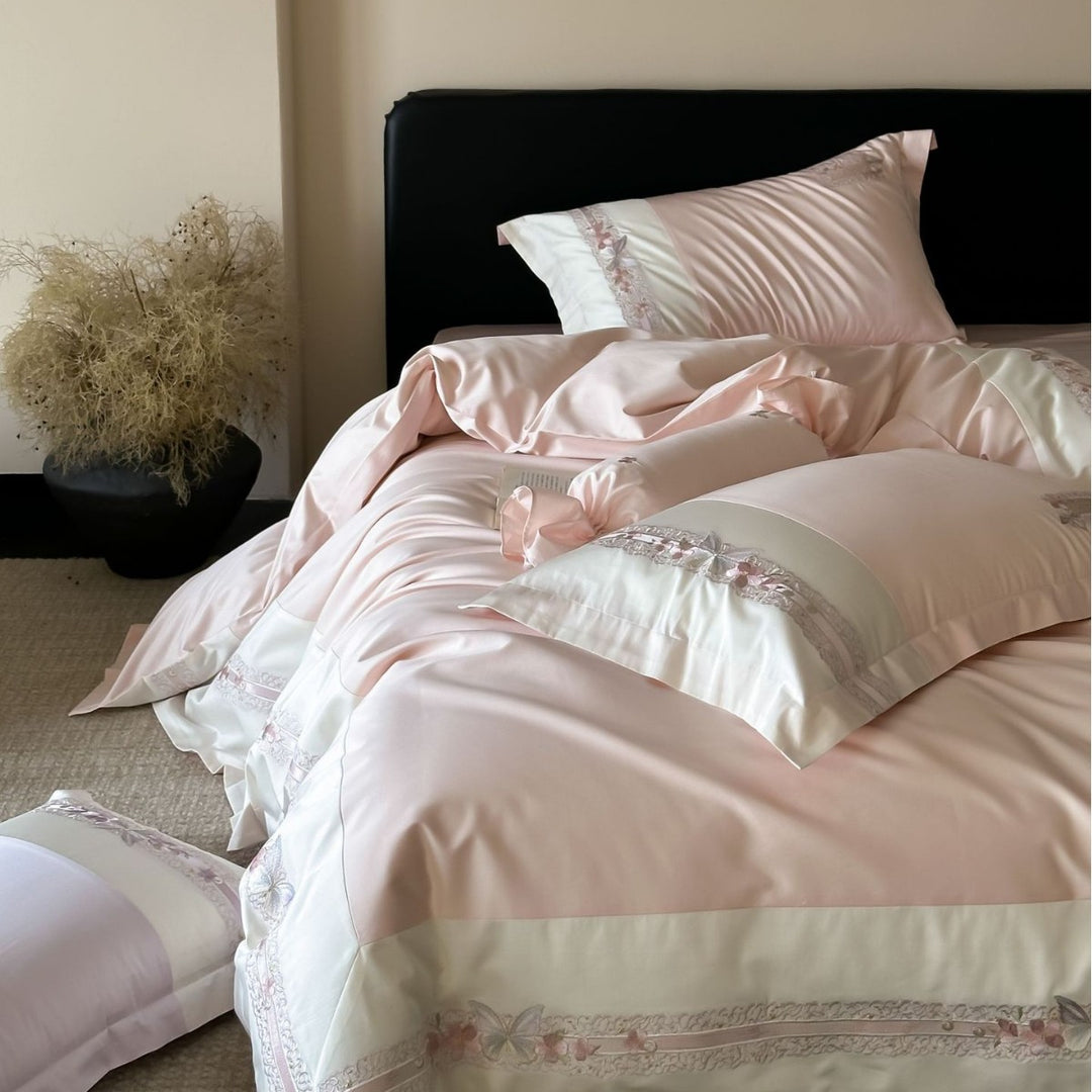 Luxurious cotton satin bed linen set with appliquéd flowers and decorative rolled hem