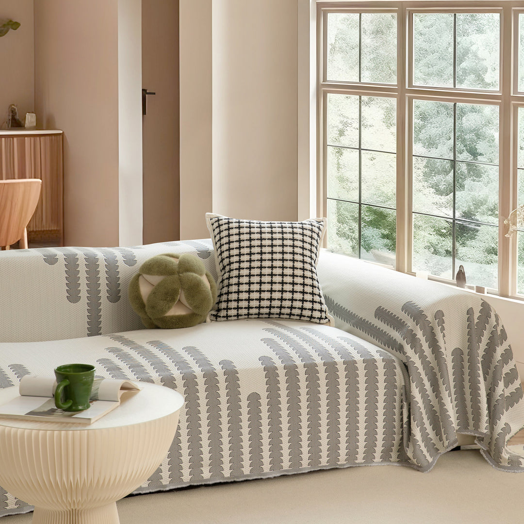 Elastic sofa cover made of jacquard cotton blend fabric with graphic relief pattern