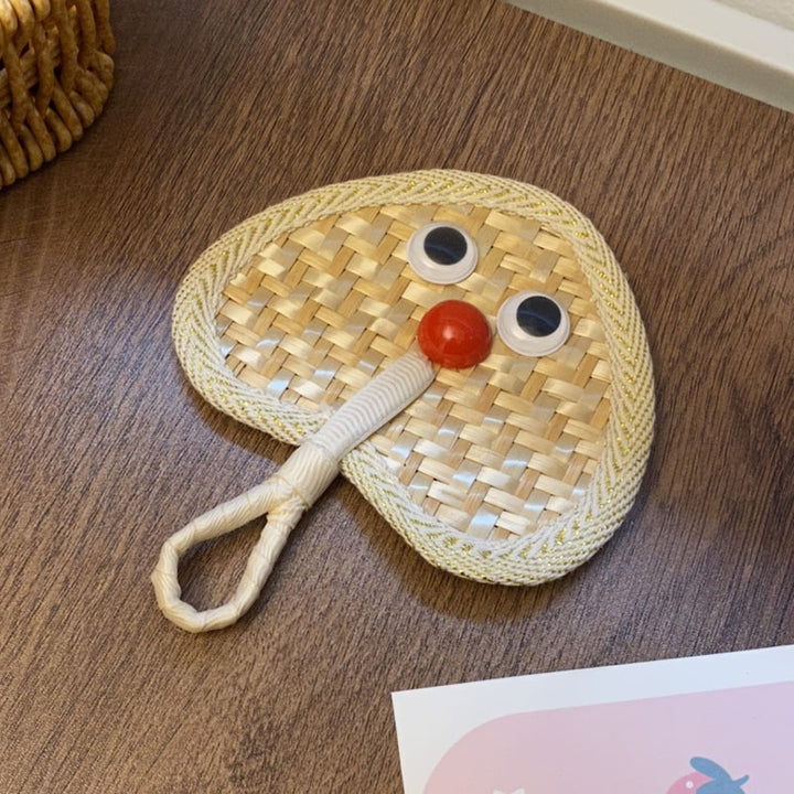 Handcrafted fan with playful face motif Kalsten