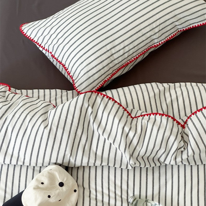 Striped cotton percale bedding set with contrasting decorative piping