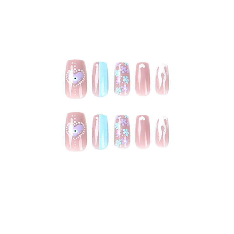 Artful nail art with floral accents and glitter embellishments Kalsten