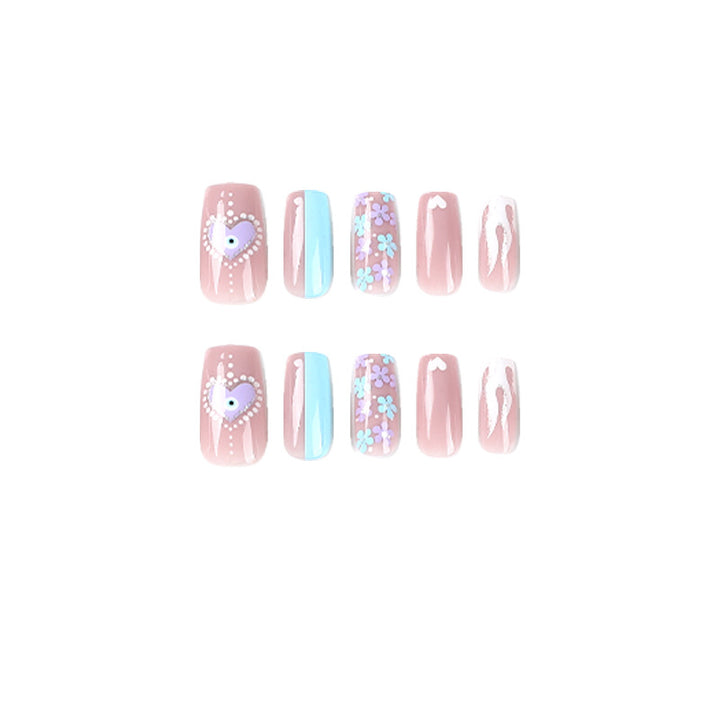 Artful nail art with floral accents and glitter embellishments Kalsten