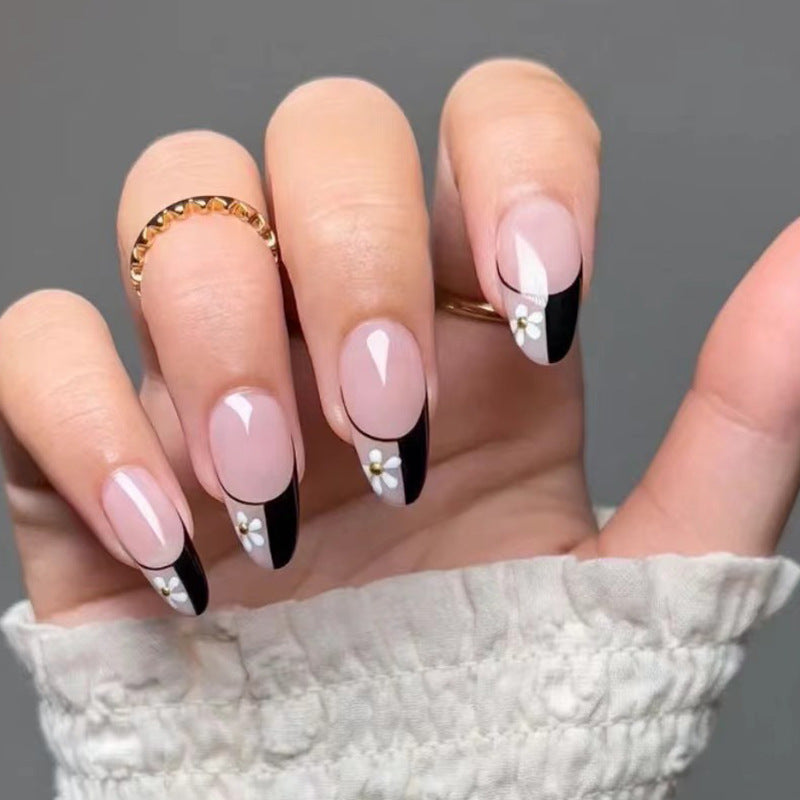 Artful nail art with elegant black-and-white design and floral accents Kalsten
