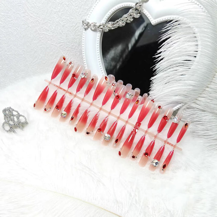 Glamorous artificial nails with sparkling ombre effect and elegant embellishments Kalsten
