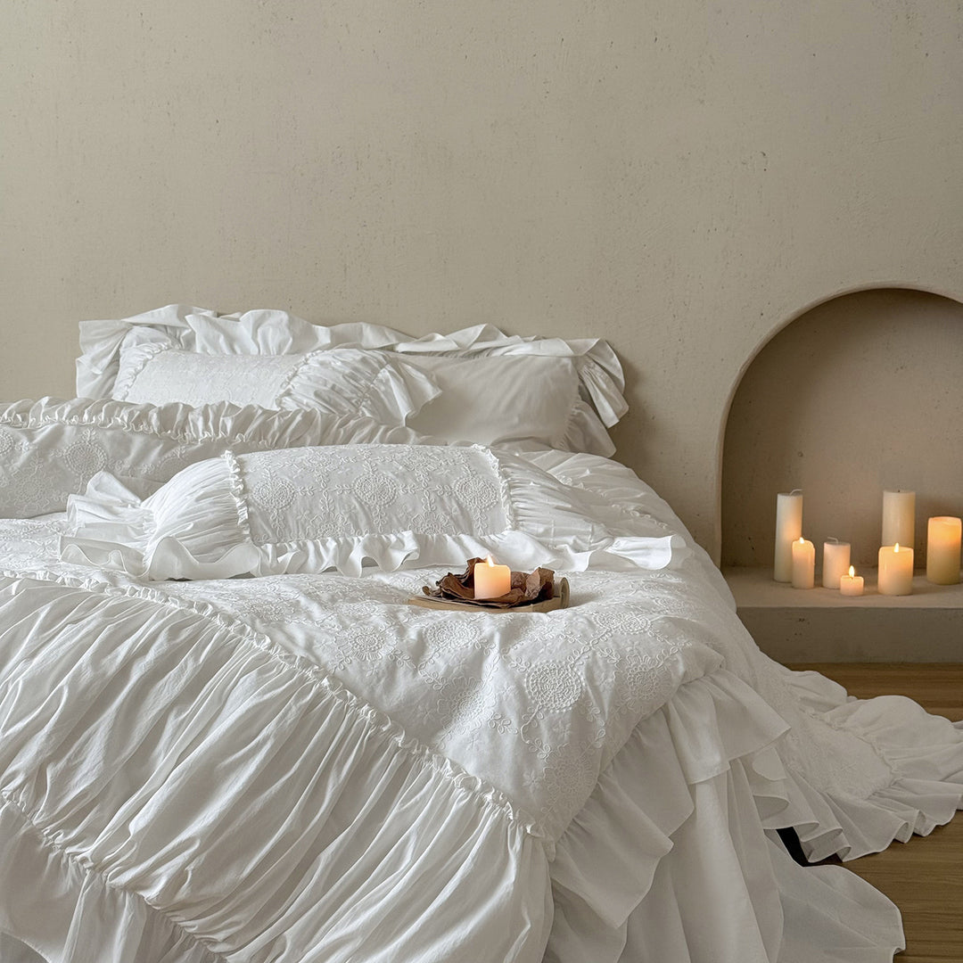 Romantic broderie anglaise bedding set with ruffle, quilted bedspread and decorative cushion