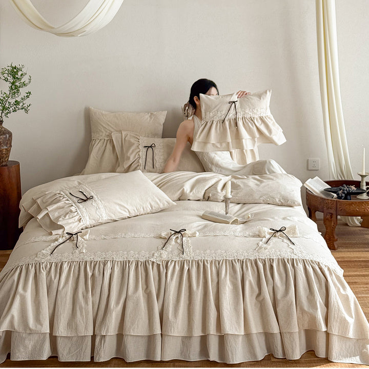 Ruffled bedding set with lace borders and decorative ribbons