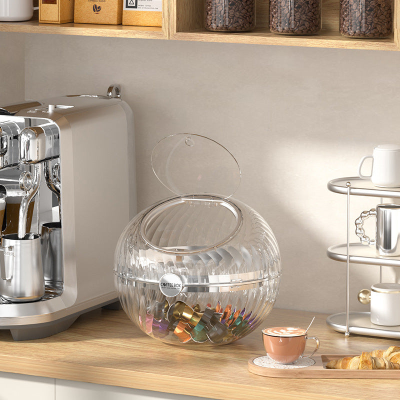 Spherical coffee capsule dispenser made of clear acrylic with flip lid