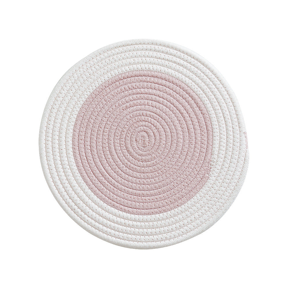 Round handwoven table placemat made of cotton yarn with structured spiral binding