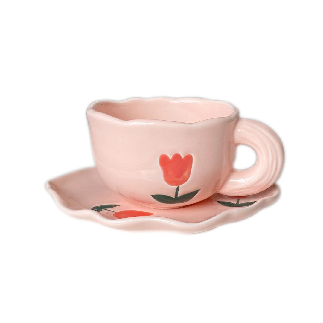 Ceramic coffee set with playful bear reliefs and organic wave saucer