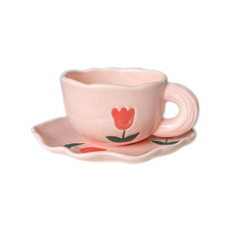Ceramic coffee set with playful bear reliefs and organic wave saucer