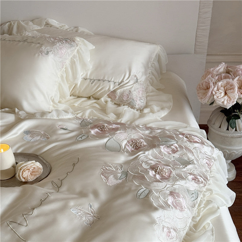 Luxurious satin bed linen set with relief-embroidered rose appliqués and ruffles