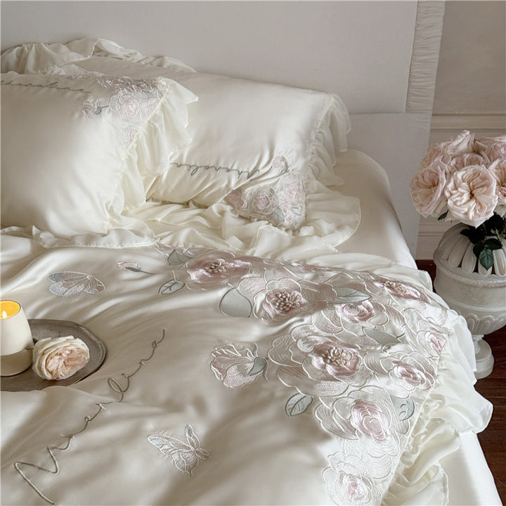 Luxurious satin bed linen set with relief-embroidered rose appliqués and ruffles