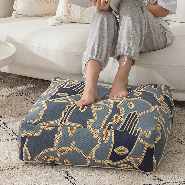 Square floor cushion cover with embroidered line pattern and carrying handle