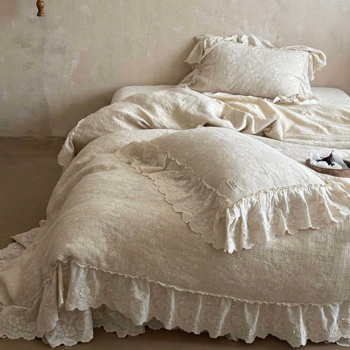Vintage-inspired ruffled bedding set made of cotton muslin with fine floral embroidery