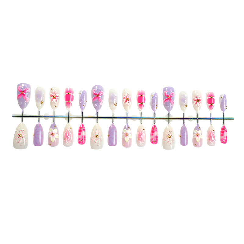 Creative acrylic nail set with floral accents and glitter decorations Kalsten