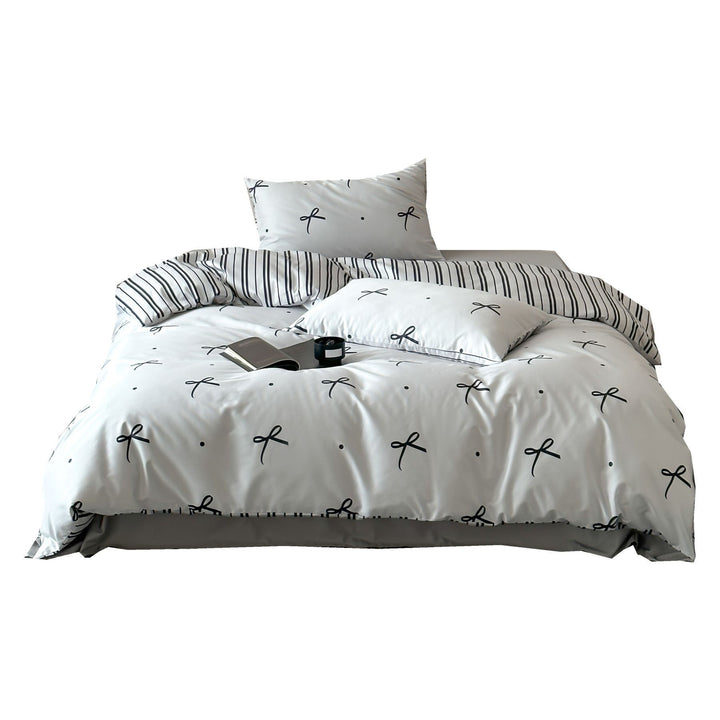 Modern cotton bedding set with minimal bow print and striped reversible side