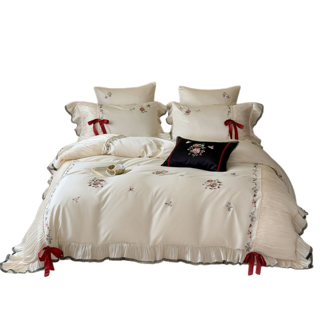 Elegant satin bedding set with pleated ruffle, rose embroidery, and bow appliqué