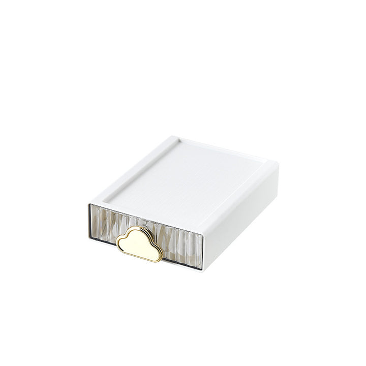 Small jewelry storage box with ribbed front and decorative cloud handle