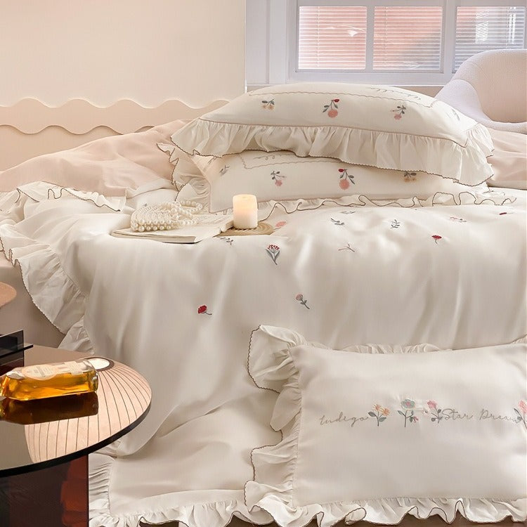 Romantic cotton satin bedding set with delicate floral embroidery and ruffle trim