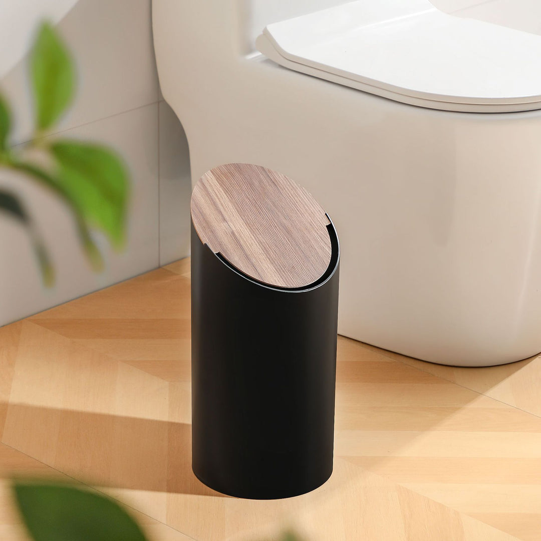Modern oval waste bin with rotating wooden lid and noise-dampening opening