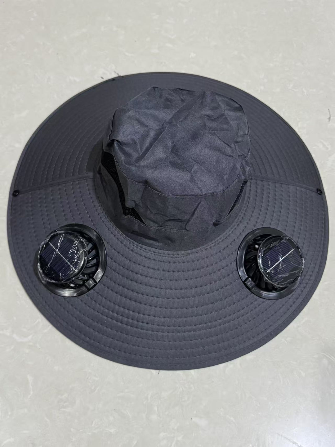 Ventilated sun hat with integrated battery fans, breathable mesh inserts, and adjustable chin strap Kalsten