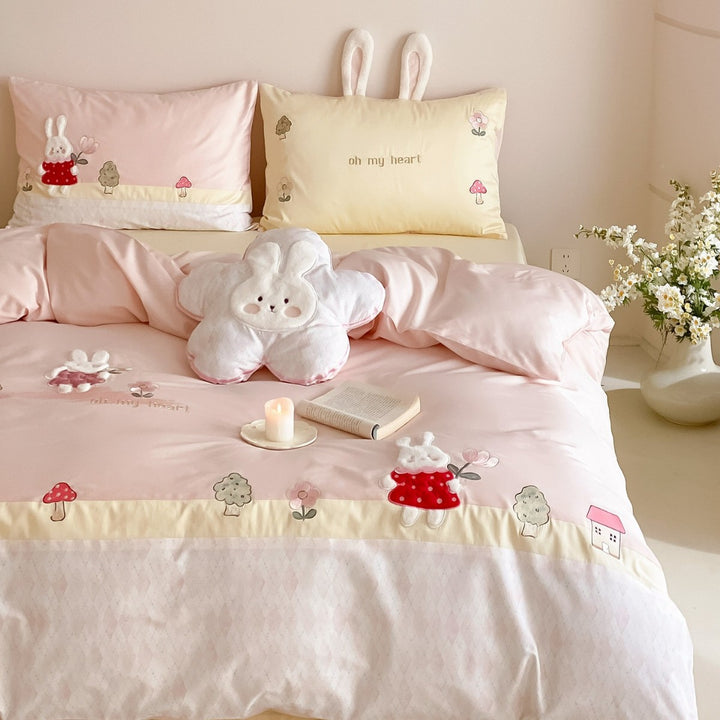 Playful cotton satin bed linen set with embroidered bunny appliqués and plush pillow
