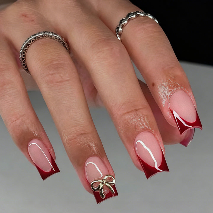 Artificial nail set with elegant red tips and refined bow decorations Kalsten