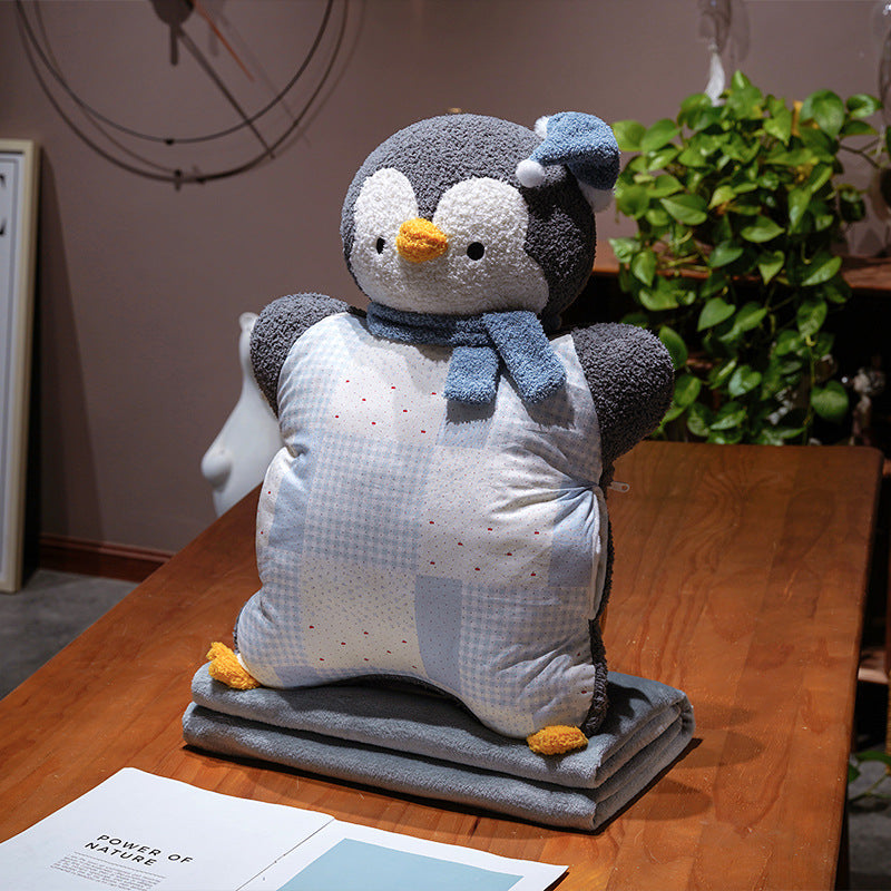 Cozy plush pillow with integrated blanket in penguin look