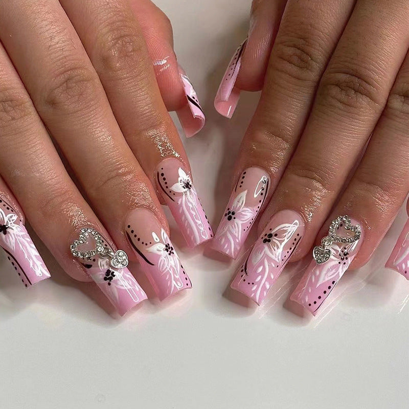 Artistic nail art with flower and heart motifs Kalsten