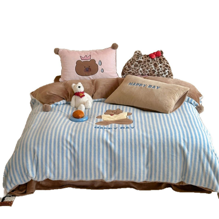Striped plush throw blanket with decorative pom poms and appliqués