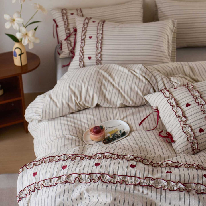Striped bedding set with ruffles and heart applique
