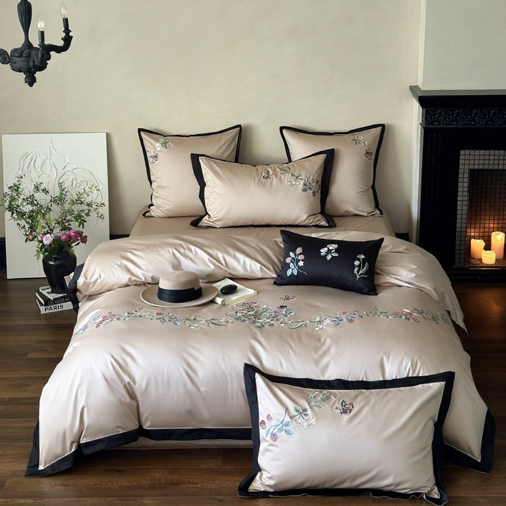 Luxurious embroidered satin bedding set with contrast piping and decorative pillow