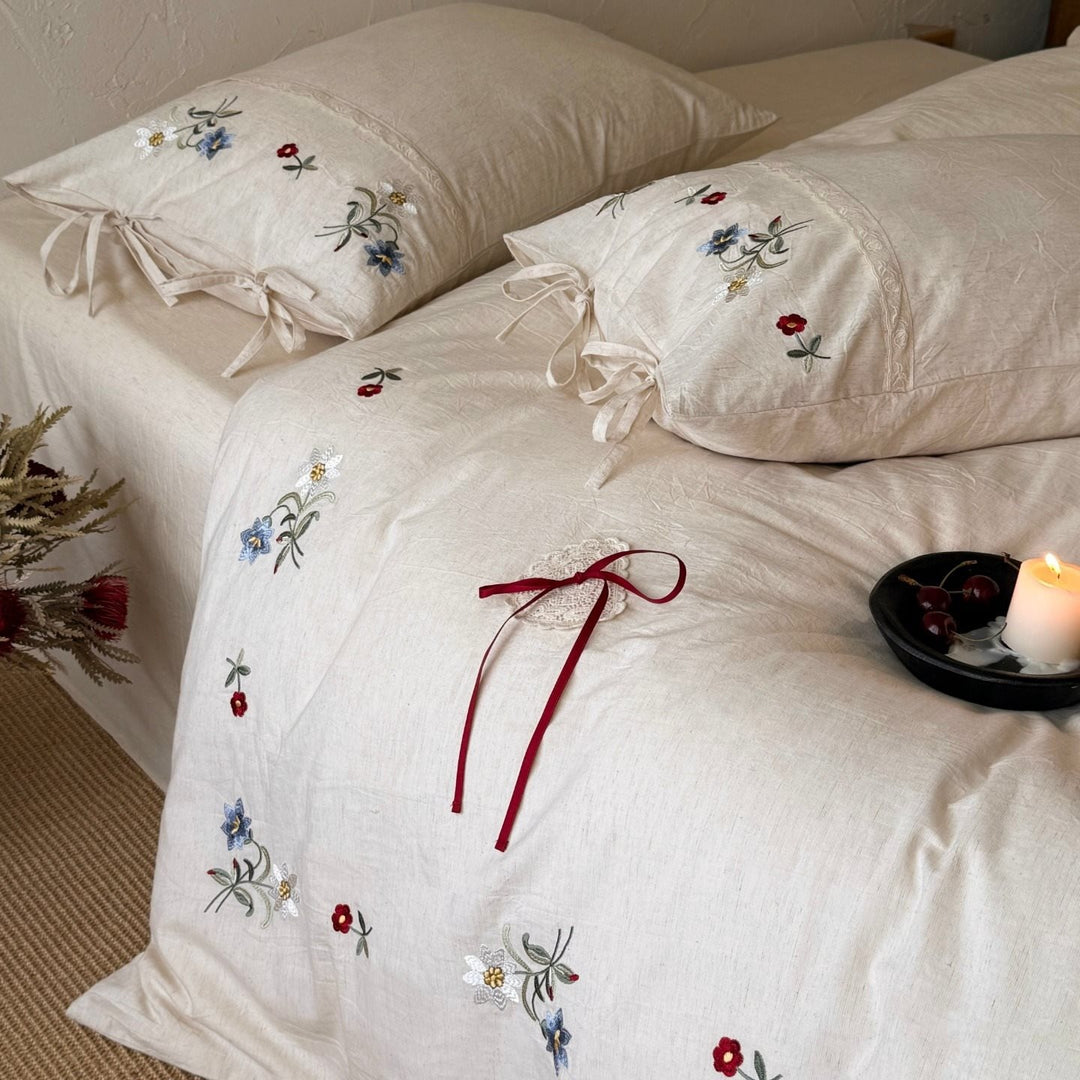 Bedding set made of linen look with floral embroidery and bow closure