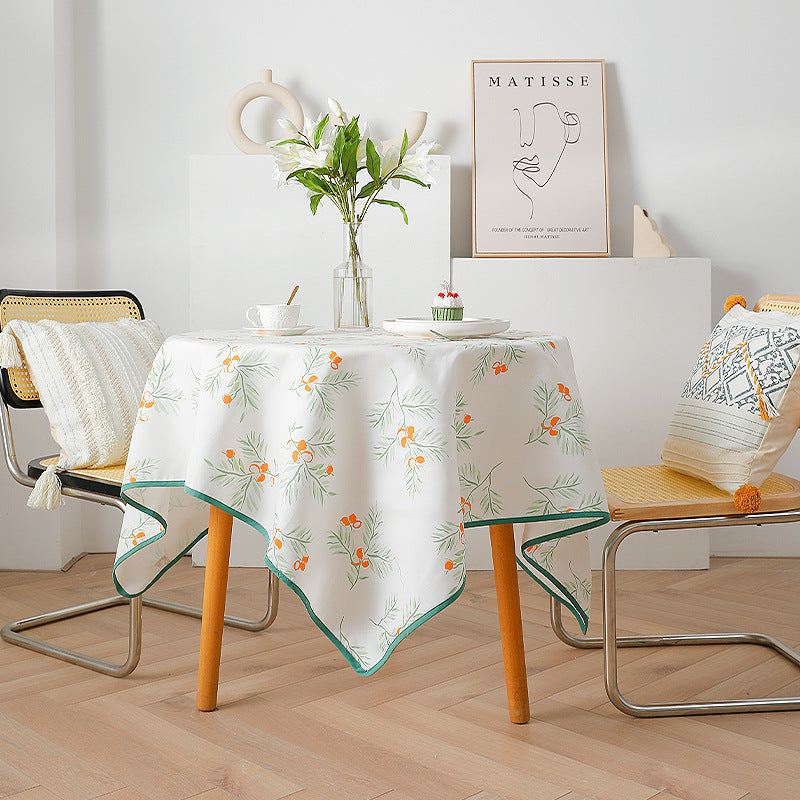 Rectangular washable cotton-polyester tablecloth with contrasted decorative edge and botanical print