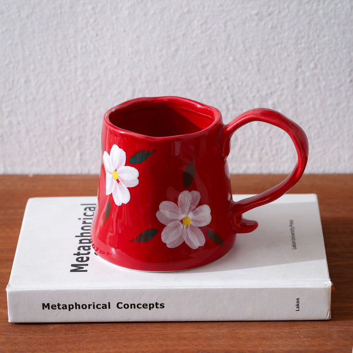 Hand-shaped ceramic mug with cloud relief and organic edge