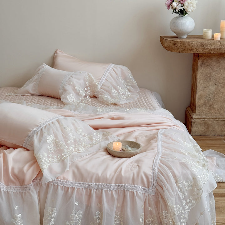 Satin bed linen set with embroidered chiffon ruffle and quilted bedspread