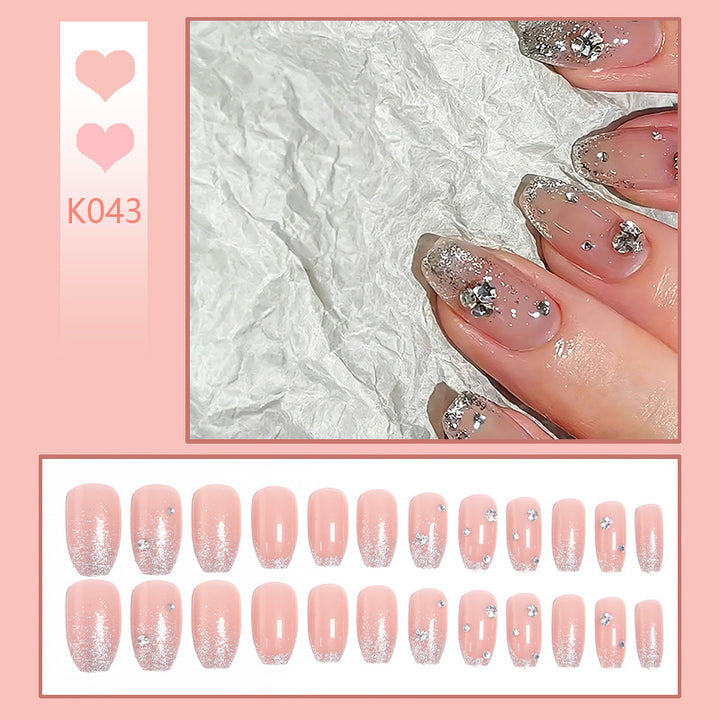 Glamorous artificial nails with glitter and rhinestone embellishments Kalsten