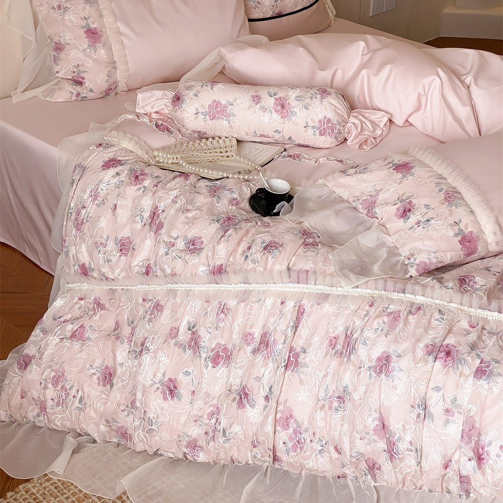 Romantic quilted bedding set with ruffles and floral pattern