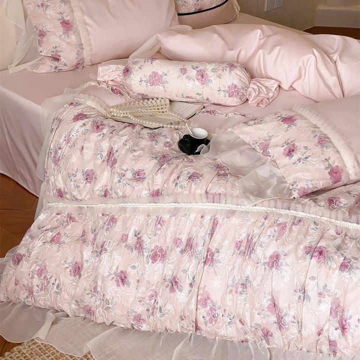 Romantic quilted bedding set with ruffles and floral pattern