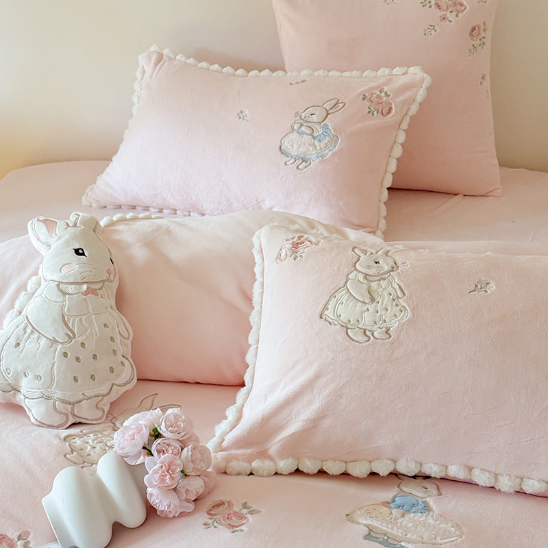Cute cotton bedding set with embroidered bunny appliqués and pom-pom trim