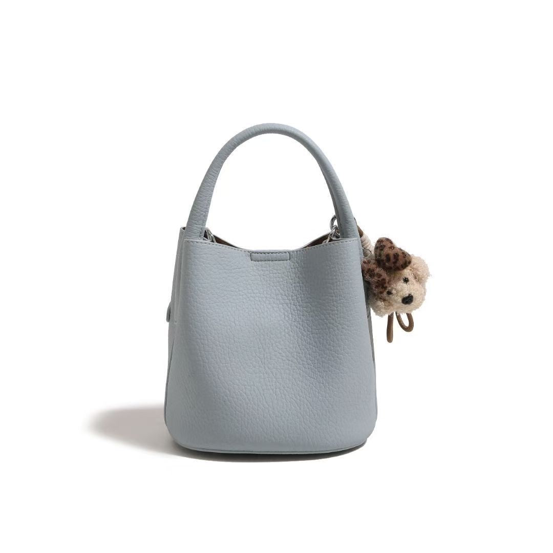 Chic Pebbled Leather Handbag with Cute Charm