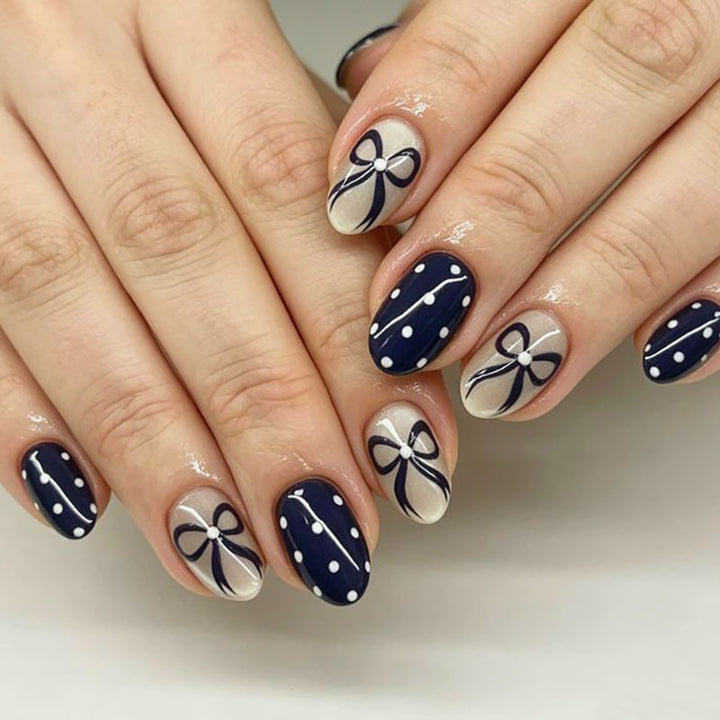 Decorative Nail Art with Bow and Polka Dot Design
