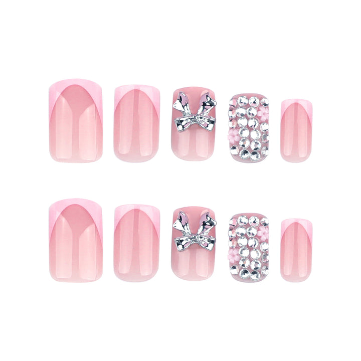 Artful nail art with glitter accents and bow decoration Kalsten