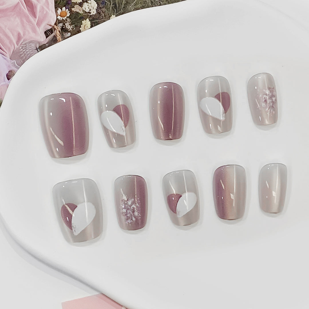 Artistic acrylic nails with heart-shaped accents Kalsten