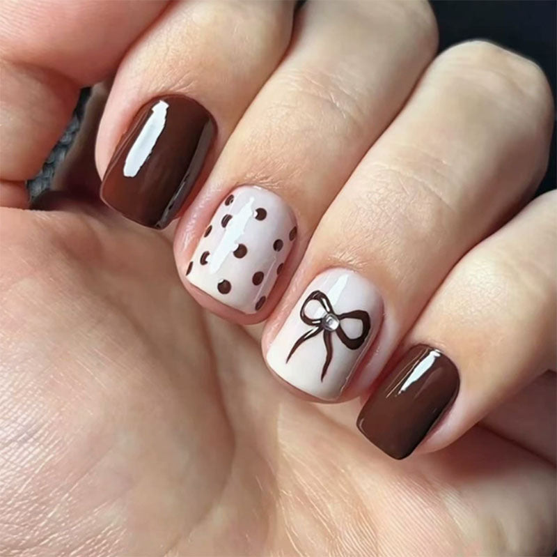 Decorative Press-On Nail Design with Bow and Polka Dots